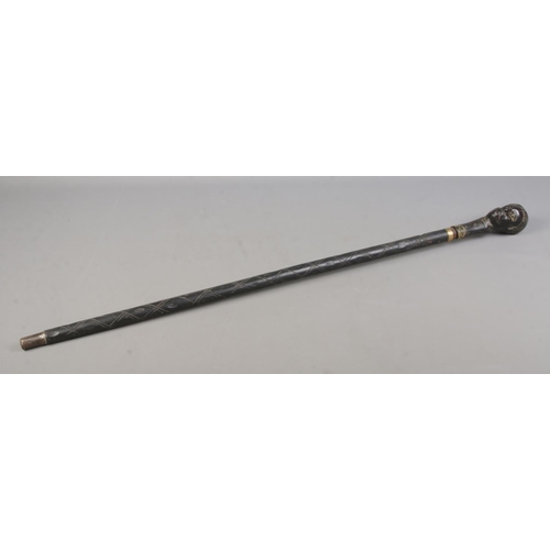 210 - An early 20th century African tribal sword stick with carved bust pommel. Length 94cm. CANNOT POST O... 