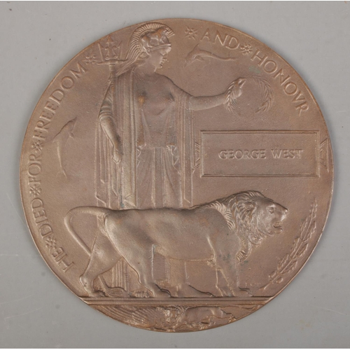 214 - A World War One bronze memorial plaque/death penny awarded to George West.