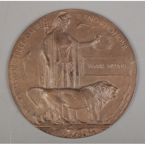 215 - A World War One bronze memorial plaque/death penny awarded to Frank Pilling.