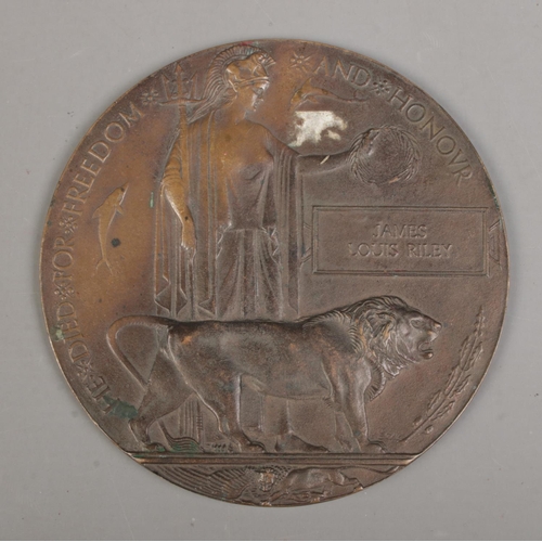 218 - A World War One bronze memorial plaque/death penny awarded to James Louis Riley.