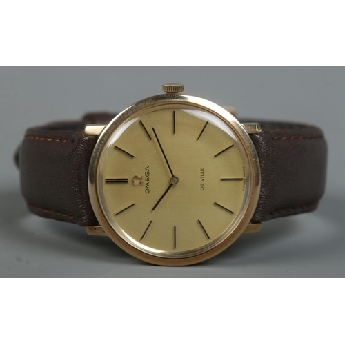 225 - A gents 9ct gold Omega De Ville manual wristwatch. Having champagne dial and baton markers.