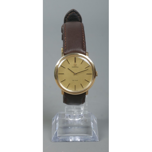 225 - A gents 9ct gold Omega De Ville manual wristwatch. Having champagne dial and baton markers.