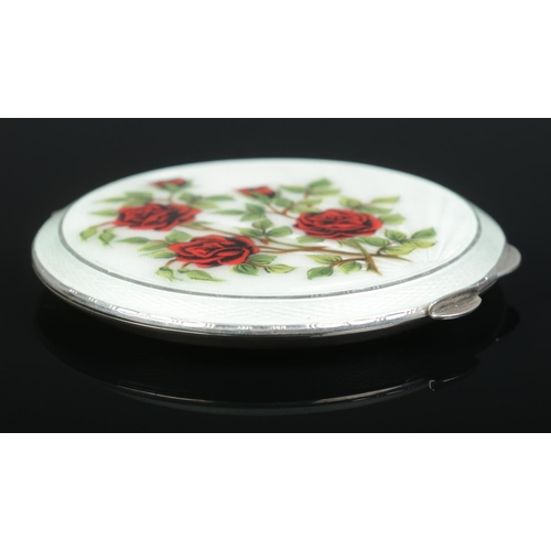 227 - A silver and enamel compact with rose decoration. Assayed Birmingham 1961 by Henry Clifford Davis. 8... 