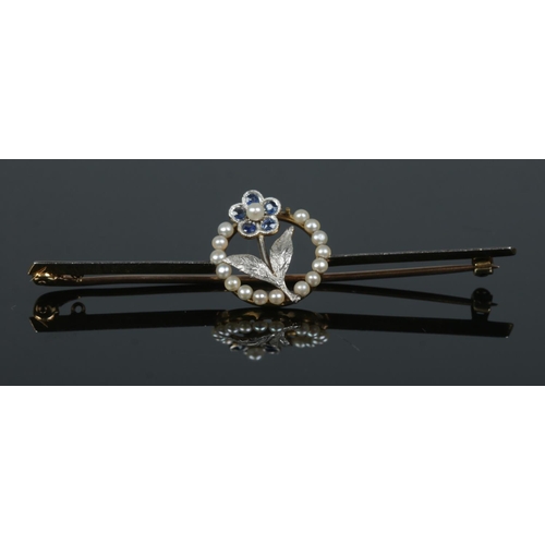 245 - A 15ct gold, platinum, sapphire and pearl knife edge brooch with floral decoration. In case. Length ... 