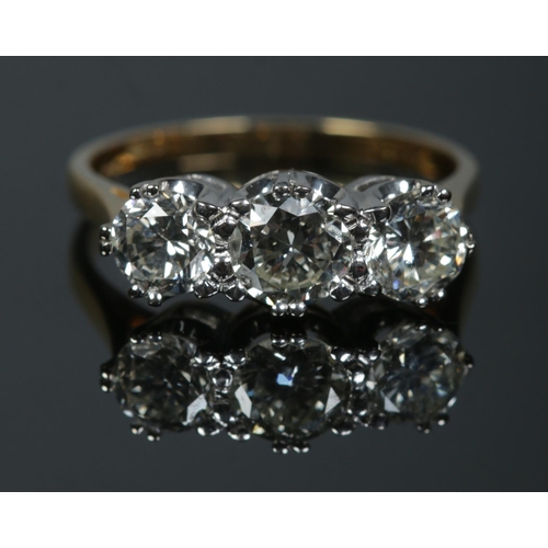 251 - An 18ct gold three stone diamond ring. Approximately 1.9ct diamond in total. Has original sale recei... 