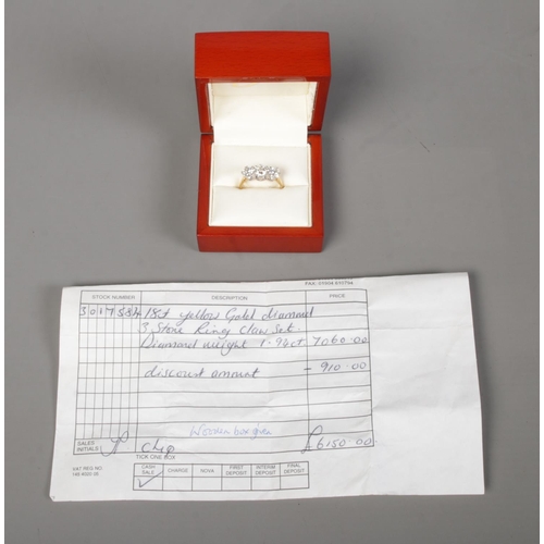 251 - An 18ct gold three stone diamond ring. Approximately 1.9ct diamond in total. Has original sale recei... 