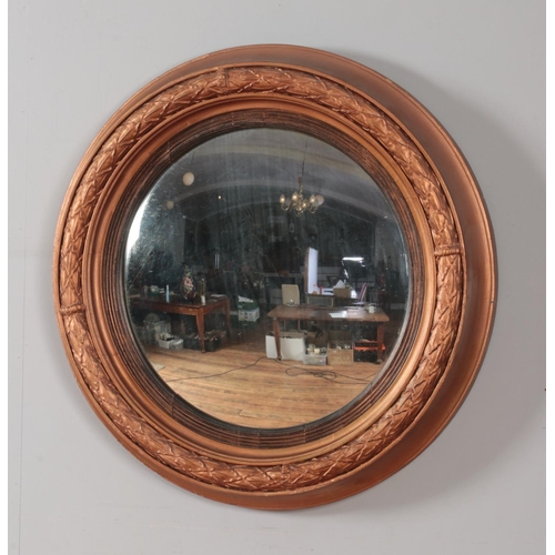 266 - A large gilt wood framed convex mirror. Diameter 68cm.