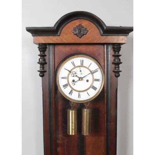 269 - A 19th century walnut Vienna twin weight wall clock. Chiming on a coiled gong.