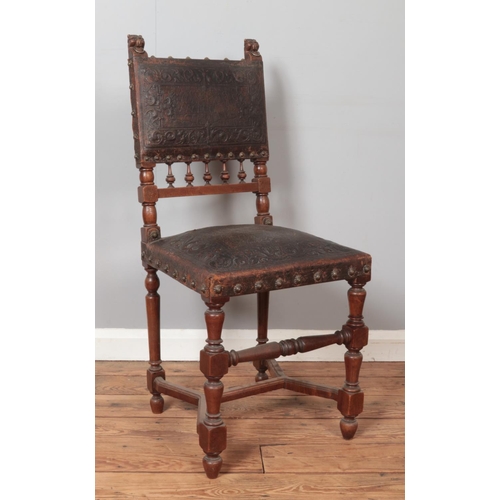 276 - A set of four antique carved mahogany chairs. Having lion mask terminals, tooled leather seats and b... 