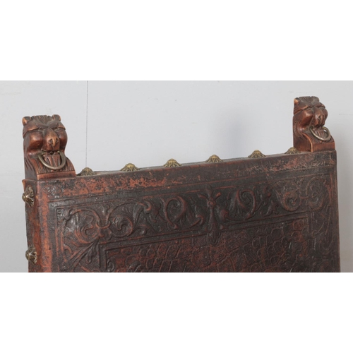 276 - A set of four antique carved mahogany chairs. Having lion mask terminals, tooled leather seats and b... 