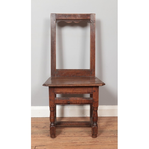 278 - A small late 18th/early 19th century oak chair of jointed construction. Height of back 88cm.