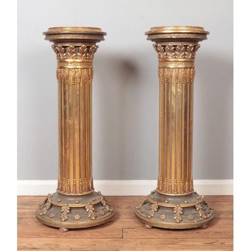 282 - A large pair of gilt wood Corinthian columns. Height 101cm.