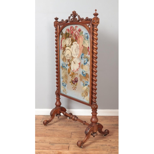 283 - A large Victorian mahogany framed fire screen with floral woolwork panel and barley twist supports. ... 