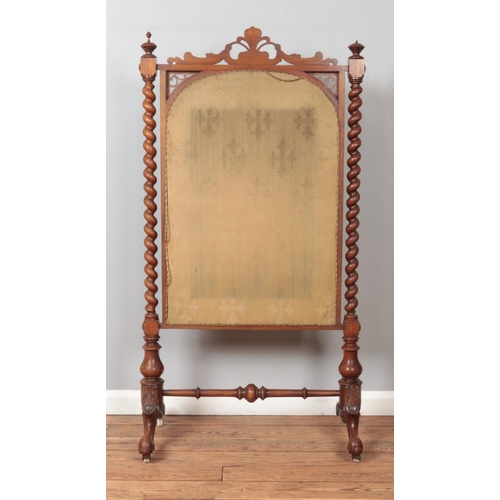 283 - A large Victorian mahogany framed fire screen with floral woolwork panel and barley twist supports. ... 