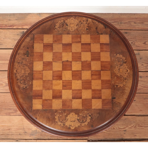 284 - A Victorian inlaid walnut games table with carved centre support and tripod base. Height 69cm.