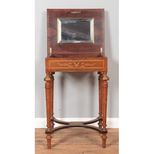 285 - An Edwardian marquetry inlaid vanity table. With fitted mirrored and fitted interior. Height 75cm.