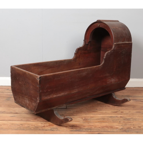 286 - A Victorian mahogany and pine rocking crib. Height 74.5cm, Length 100cm.