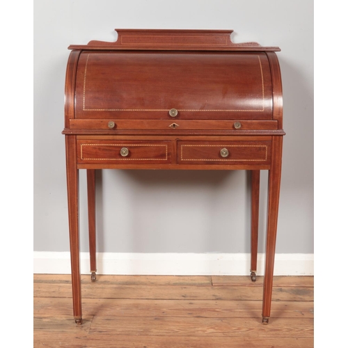 287 - An Edwardian mahogany cylinder desk, having fitted interior, tapering supports and strung inlay. Hei... 