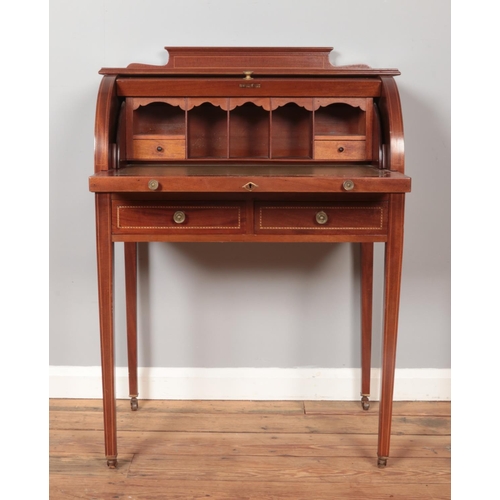 287 - An Edwardian mahogany cylinder desk, having fitted interior, tapering supports and strung inlay. Hei... 