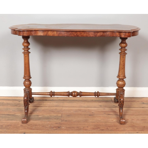 288 - A Victorian burr walnut centre table. With quarter veneered top and raised on turned and carved supp... 