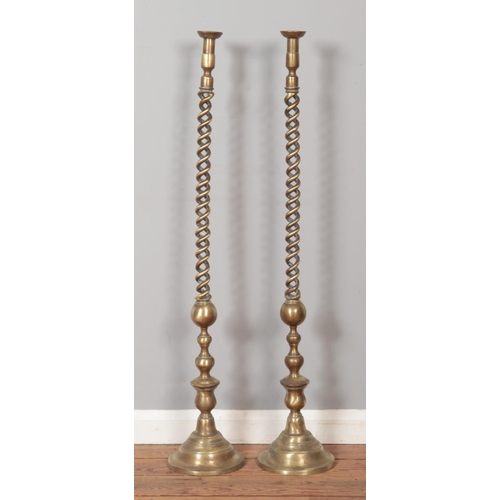 290 - A pair of large brass barley twist candle stands. Height 117cm.