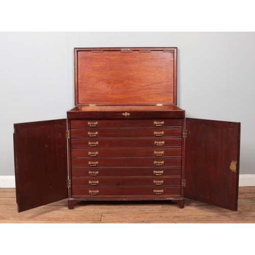 293 - A mahogany floor standing collectors chest. Having hinged top, cabinet front and eight glass topped ... 