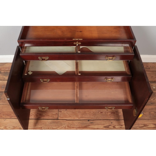 293 - A mahogany floor standing collectors chest. Having hinged top, cabinet front and eight glass topped ... 