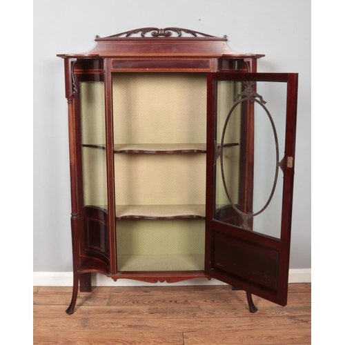 294 - An Edwardian carved and inlaid mahogany display cabinet. Height 149cm, Width 113cm, Depth 38cm.