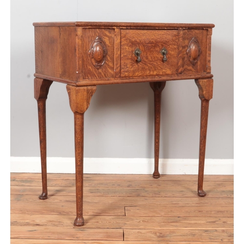 298 - A carved oak side table with single drawer. Raised on cabriole supports. Height 91cm, Width 79cm, De... 