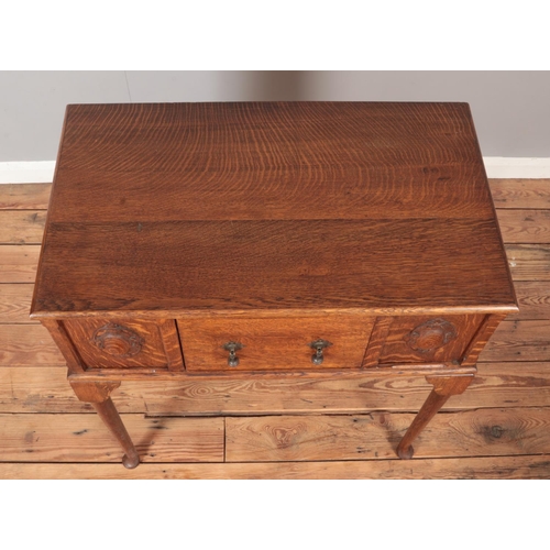 298 - A carved oak side table with single drawer. Raised on cabriole supports. Height 91cm, Width 79cm, De... 