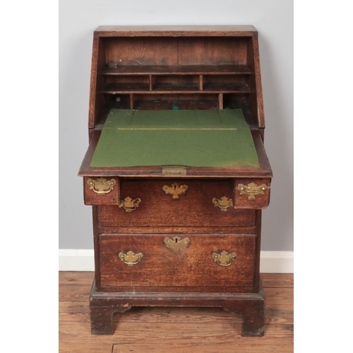 300 - A small oak Georgian bureau. Height 104.5cm, Width 58.5cm, Depth 48cm.