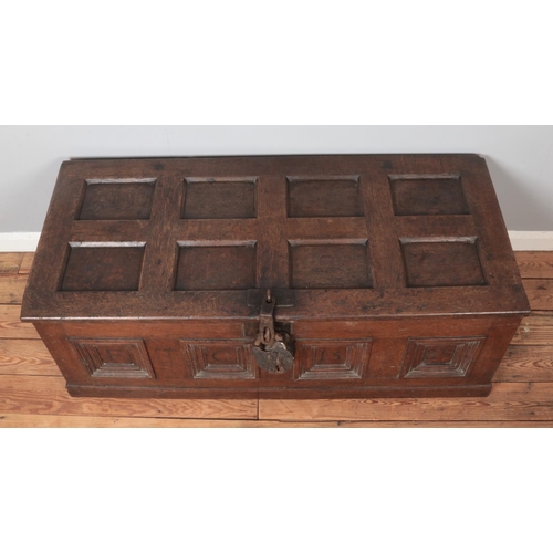 301 - An antique panelled oak coffer. Carved to the front with initials FC and dated 1589. Height 51cm, Wi... 