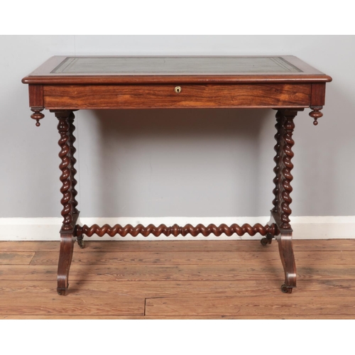 303 - A Victorian rosewood writing table. Having leather inset top, single drawer and barley twist support... 