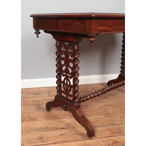 303 - A Victorian rosewood writing table. Having leather inset top, single drawer and barley twist support... 