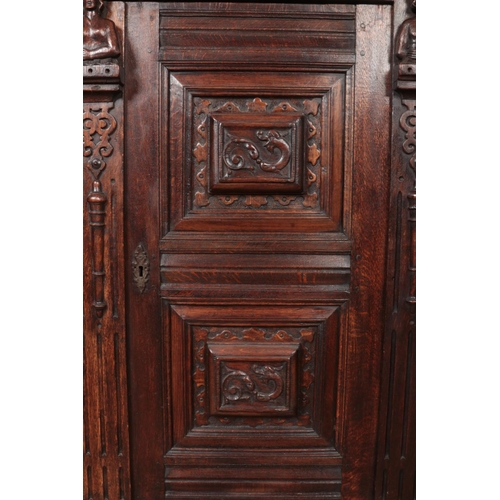 309 - A carved and panelled oak Flemish cabinet. Height 177cm, Width 135cm, Depth 64cm.