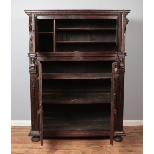 309 - A carved and panelled oak Flemish cabinet. Height 177cm, Width 135cm, Depth 64cm.