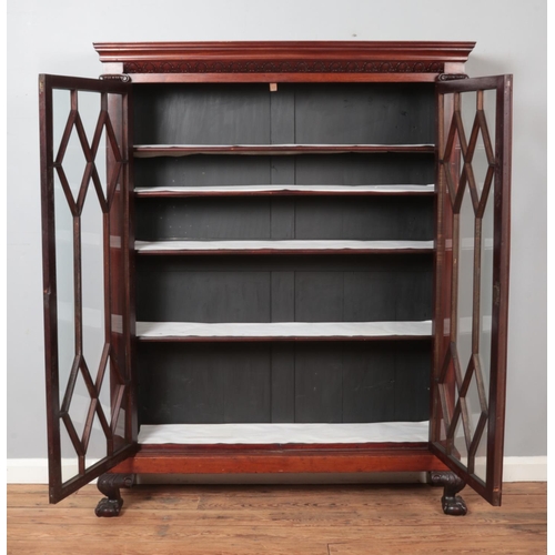 315 - A large astragal glazed mahogany cabinet. Raised on ball and claw feet with carved shell motif decor... 