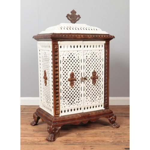 318 - An enamel cast iron stove with lion paw feet and urn shaped finial. Height 102cm, Width 59cm, Depth ... 