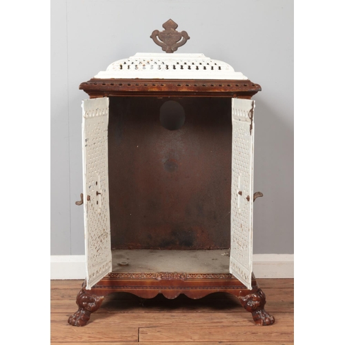 318 - An enamel cast iron stove with lion paw feet and urn shaped finial. Height 102cm, Width 59cm, Depth ... 