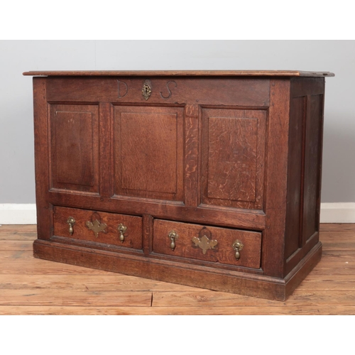 319 - A 19th century oak mule chest with triple panelled front and two drawers with tear drop handles and ... 