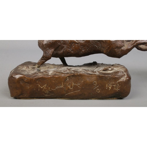 63 - Michael Lyne, a set of three bronze sculptures modelled as two coursing dogs chasing a hare. All sig... 