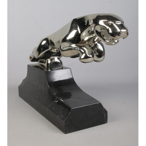 66 - A large cast white metal sculpture of a Jaguar raised on marble base. Length 68cm, Height 34cm.