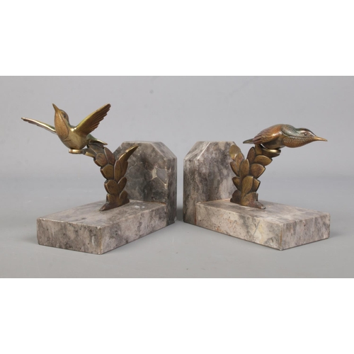 71 - A pair of bronze and marble book ends, surmounted with exotic birds.