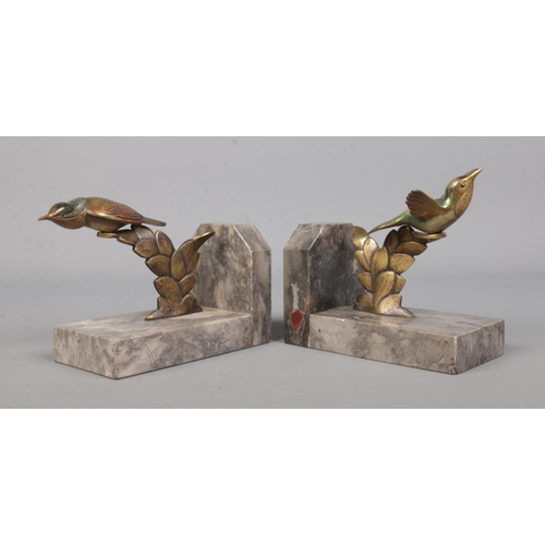 71 - A pair of bronze and marble book ends, surmounted with exotic birds.