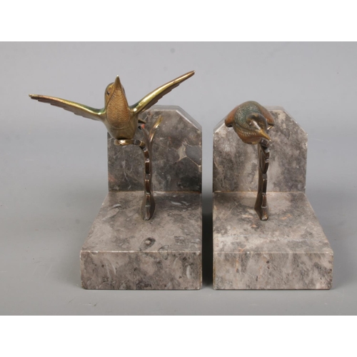 71 - A pair of bronze and marble book ends, surmounted with exotic birds.