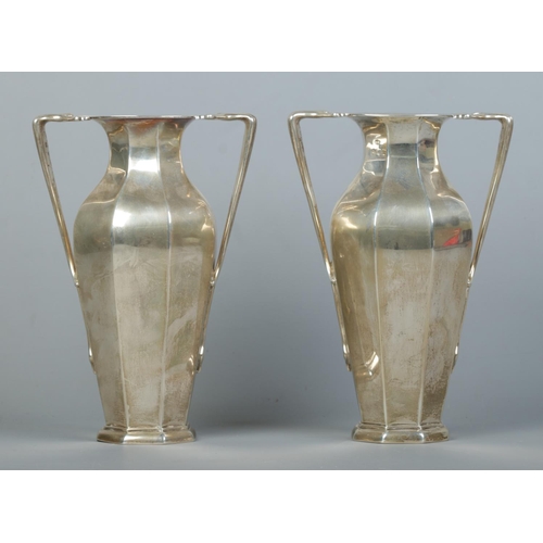 84 - A pair of Edwardian silver twin handled vases of octagonal baluster form. Assayed London 1903 by Cha... 