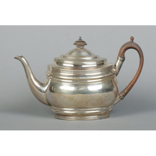 86 - A George III silver teapot with wooden handle and turned finial. Assayed London 1804 by Samuel Godbe... 