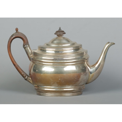 86 - A George III silver teapot with wooden handle and turned finial. Assayed London 1804 by Samuel Godbe... 