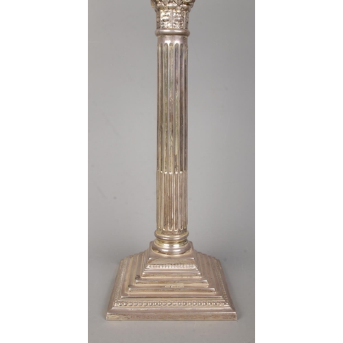 97 - A large George V silver twin branch candelabra with Corinthian column and stepped base. Assayed Lond... 