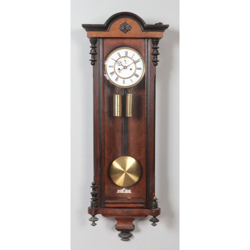 269 - A 19th century walnut Vienna twin weight wall clock. Chiming on a coiled gong.